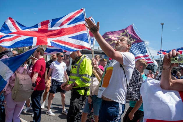July 4, 2026, Dover, United Kingdom: A far-right protester makes gesture to the antifascists during a demonstration in Dover. Around 100-120 supporters of the Pink Ladies gathered from across the country in Dover, UK. The Pink Ladies is an anti immigration far-right movement. The far-right activists marched through central Dover to the Immigration Centre and they were confronted by a small group of antifascist counter-protesters during their march. Dover United Kingdom - ZUMAs197 20260704_aaa_s197_230 Copyright: xKrisztianxElekx