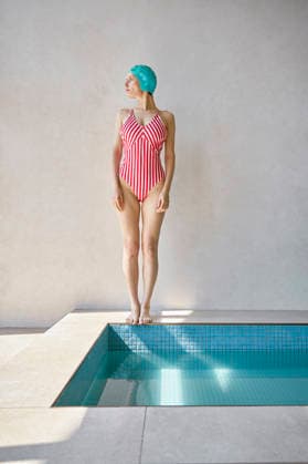 Contemplative woman standing barefoot by hot tub at spa model released, Symbolfoto property released, EKHF00037