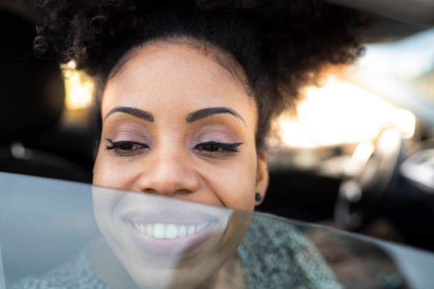 Woman smiling while looking through car window model released, Symbolfoto, JCCMF02806