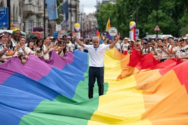 July 4, 2026, London, United Kingdom: London Mayor Sadiq Khan stands on LGBTQ+ flag during the parade. Participants take part in the annual Pride in London parade through central London, celebrating LGBTQ+ communities and advocating for visibility, unity and equality. Thousands of marchers, community groups, charities, businesses and campaign organisations join the procession, which travels through the capital with colourful costumes, banners, music and performances. Participants take part in the annual Pride in London parade through central London, celebrating LGBTQ+ communities and advocating for visibility, unity and equality. Thousands of marchers, community groups, charities, businesses and campaign organisations join the procession, w  - ZUMAs197 20260704_aaa_s197_288 Copyright: xAndreaxDomeniconix