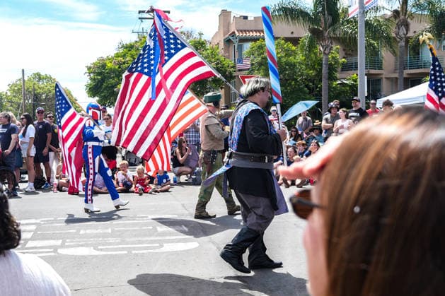 July 4, 2026, Coronado, California, United States: People carry flags of the United States as they march through the streets. Spectators line Orange Avenue as participants march through the annual Independence Day Parade in Coronado on July 4, 2026. The parade, featuring marching bands, military units, community organizations, and decorated vehicles, was part of the city s Independence Day celebrations marking America s 250th birthday and drew thousands of residents and visitors to the coastal community of San Diego area. Coronado United States - ZUMAs197 20260704_aaa_s197_361 Copyright: xMichaelxHoxWaixLeex