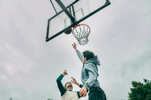 Teenage boy playing basketball outside with his father model released, Symbolfoto, ANAF06182