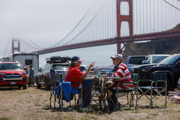 A couple played cards as they awaited for the fireworks display on the Golden Gate Bridge for the 250th anniversary of the United States in Sausalito, California on Saturday, July 4, 2026.  SFP20260704302 PETERxDASILVA