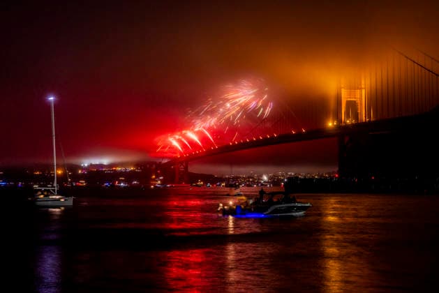 Spectators watch the fireworks display on the Golden Gate Bridge for the 250th anniversary of the United States from Horseshoe Bay in Sausalito, California on Saturday, July 4, 2026.  SFP20260704306 PETERxDASILVA