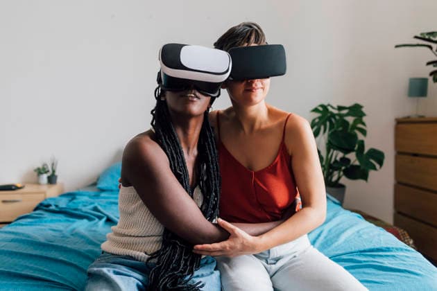 Young lesbian couple wearing virtual reality simulators in bedroom model released, Symbolfoto property released, MEUF07951
