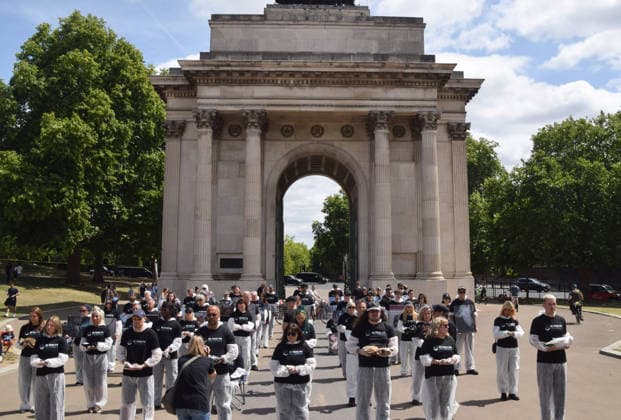 July 5, 2026, London, England, United Kingdom: Animal rights activists stand next to the Wellington Arch at Hyde Park Corner during a vigil by the group We Stand For The Animals for the billions of animals exploited, abused and killed by humans for food, clothing, entertainment and other areas of human activity. The activists held pictures of various species as well as bodies of real animals, who died of natural causes, in remembrance of animals worldwide and in protest against speciesism. London United Kingdom  - ZUMAv130 20260705_zip_v130_002 Copyright: xVukxValcicx
