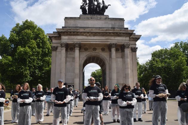 July 5, 2026, London, England, United Kingdom: Animal rights activists stand next to the Wellington Arch at Hyde Park Corner during a vigil by the group We Stand For The Animals for the billions of animals exploited, abused and killed by humans for food, clothing, entertainment and other areas of human activity. The activists held pictures of various species as well as bodies of real animals, who died of natural causes, in remembrance of animals worldwide and in protest against speciesism. London United Kingdom  - ZUMAv130 20260705_zip_v130_004 Copyright: xVukxValcicx