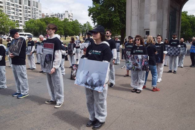 July 5, 2026, London, England, United Kingdom: Animal rights activists stand next to the Wellington Arch at Hyde Park Corner during a vigil by the group We Stand For The Animals for the billions of animals exploited, abused and killed by humans for food, clothing, entertainment and other areas of human activity. The activists held pictures of various species as well as bodies of real animals, who died of natural causes, in remembrance of animals worldwide and in protest against speciesism. London United Kingdom  - ZUMAv130 20260705_zip_v130_022 Copyright: xVukxValcicx