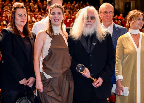 The 60th Karlovy Vary International Film Festival continued on its second day, in Karlovy Vary, Czech Republic, on July 5, 2026. Cameraman Robert Richardson (holding the trophy) accepted the Crystal Globe for Outstanding Artistic Contribution to World Cinema and introduced the documentary film Robert Richardson: The White Devil by director and cameraman Jana Hojdova (to his right). (CTKxPhoto KaterinaxSulova) CTKPhotoP2026070503720  CTKPhotoP2026070503720