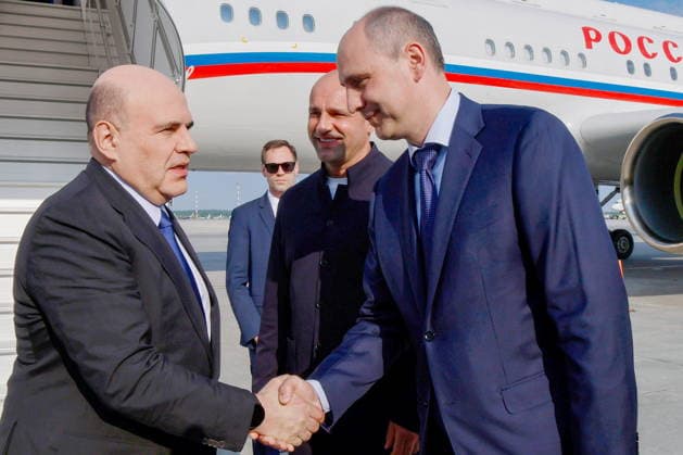 RUSSIA, YEKATERINBURG - JULY 5, 2026: Russia s Prime Minister Mikhail Mishustin and Sverdlovsk Region Governor Denis Pasler (L-R front) shake hands at Koltsovo International Airport. Pictured 2nd R is Presidential Plenipotentiary Envoy to the Ural Federal District Artyom Zhoga. Mikhail Mishustin is on a working visit to Yekaterinburg to participate in the 16th Innoprom International Industrial Exhibition, which is taking place on 6-9 July. Dmitry Astakhov POOL TASS  94709791