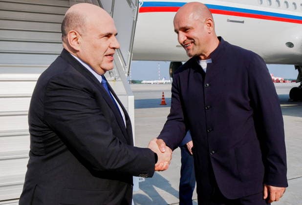 RUSSIA, YEKATERINBURG - JULY 5, 2026: Russia s Prime Minister Mikhail Mishustin (L) and Presidential Plenipotentiary Envoy to the Ural Federal District Artyom Zhoga shake hands at Koltsovo International Airport. Mikhail Mishustin is on a working visit to Yekaterinburg to participate in the 16th Innoprom International Industrial Exhibition, which is taking place on 6-9 July. Dmitry Astakhov POOL TASS  94710605