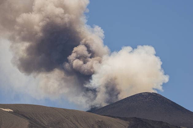 Mount Etna erupts, sending ash plume over Catania, Sicily CATANIA, ITALY - JULY 5: A towering ash plume rises from Mount Etna following the resumption of eruptive activity from a vent located on the upper eastern flank of the Voragine summit crater as the Volcano Observatory Notice for Aviation (VONA) remains at RED alert level in Catania, Sicily, Italy, on July 5, 2026. The ash emission generated an eruption column reaching approximately 1.5 kilometres above the volcano s summit, drifting toward the south and south-southeast. The effusive lava flow, which had been active since June 26, ceased on July 4, while Strombolian activity continues at the summit vent. The presence of volcanic ash prompted temporary airspace restrictions south of th  Copyright: x2026xAnadoluxSalvatorexAllegrax
