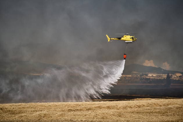 A large wildfire has been reported in Imárcoain, Navarre. Water-bombing helicopters are working to extinguish the wildfire in Imárcoain on July 5, 2026, in Imárcoain, Elorz Valley, Navarre, Spain. Firefighters are currently working to extinguish a fire in a grain field that has spread to a wooded area in Imárcoain, which belongs to the municipality of Elorz Valley. Emergency services received the alert at 4:49 p.m., and a response team consisting of firefighters, aircraft, environmental forest rangers, Local Police, and Regional Police. As a result, the AP 15 has been closed in both directions as a precaution. JULY 5, 2026 Imarcoain, Elorz Valley, Navarre Imarcoain, Elorz Valley, Navarre, Spain  Copyright: xEduardoxSanzx 7647225
