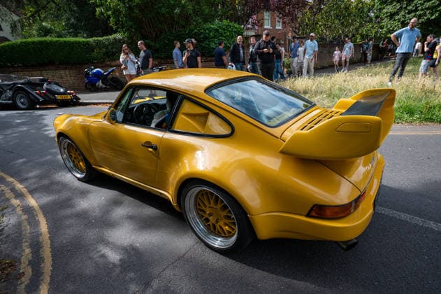 July 5, 2026, London, United Kingdom: A modified yellow 1980s Porsche Carrera driven along a London suburban road. The Southside Hustle Car Meet is held on Wimbledon Common in Southwest London every first Sunday of the month. This free community event attracts owners of classic cars, supercars, sports cars, and rare or modified vehicles. Car enthusiasts, photographers, and families gather to admire an impressive variety of cars, meet like-minded people, and enjoy the welcoming atmosphere in the scenic surroundings of Wimbledon Common. London United Kingdom  - ZUMAs197 20260705_aab_s197_004 Copyright: xJamesxWilloughbyx