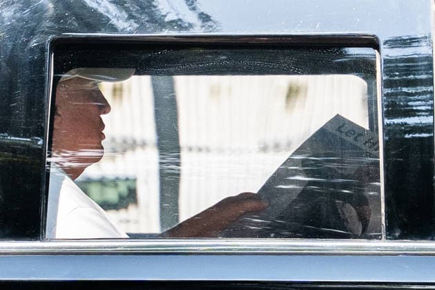 President Donald J Trump holds a display of President Volodymyr Zelenskyy of Ukraine with the text let him cook as he returns to the White House in Washington DC on Sunday, July 5, 2026.  WAX20260705901 AaronxSchwartz