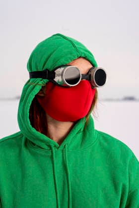 Woman with red protective face mask looking away against sky model released, Symbolfoto, VPIF03594
