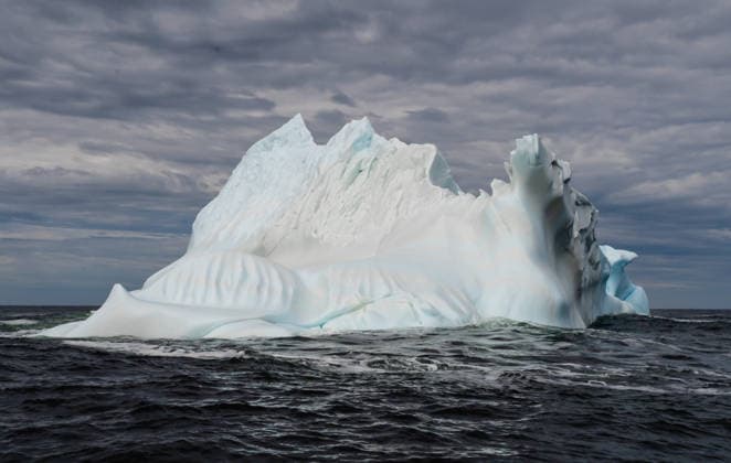 Large iceberg floats in dark choppy water off Newfoundland coast Twillingate, Newfoundland and Labrador, Canada CR_DOHO260701B-2072559-01