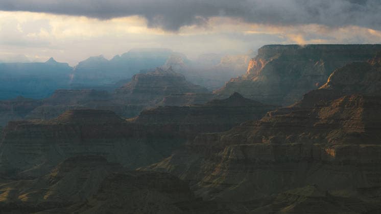 Creative Highlights World Sunlight filters through clouds over the Grand Canyon Grand Canyon Village, Arizona, United States CR_BGNT260701B-2074081-01