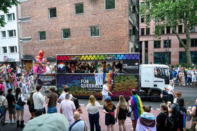 COLOGNE, GERMANY - 5 JULY, 2026: Cologne Pride parade float passes through a city street as spectators watch from both sides. Street Parade of the Christopher Street Day (CSD), Gay Pride. LGBT  Copyright: xx