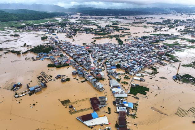 (260706) -- NANNING, July 6, 2026 -- A drone photo taken on July 6, 2026 shows the flooded downstream areas of the Liulan Reservoir after it was breached due to heavy rains in Hengzhou, Nanning City, south China s Guangxi Zhuang Autonomous Region. A severe breach occurred at a reservoir in Hengzhou, Nanning City, in south China s Guangxi Zhuang Autonomous Region on Monday morning, prompting an immediate escalation of the emergency response, local authorities said. Given the severe flood control situation, the city raised its emergency response for flood control from Level III to Level I, effective at 11:30 a.m. on Monday. The Liulan Reservoir, a medium-sized water conservancy facility in the region, reported the dam breach on Monday 