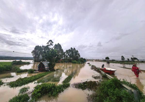 (260706) -- NANNING, July 6, 2026 -- This photo taken on July 6, 2026 shows the flooded downstream areas of the Liulan Reservoir after it was breached due to heavy rains in Hengzhou, Nanning City, south China s Guangxi Zhuang Autonomous Region. A severe breach occurred at a reservoir in Hengzhou, Nanning City, in south China s Guangxi Zhuang Autonomous Region on Monday morning, prompting an immediate escalation of the emergency response, local authorities said. Given the severe flood control situation, the city raised its emergency response for flood control from Level III to Level I, effective at 11:30 a.m. on Monday. The Liulan Reservoir, a medium-sized water conservancy facility in the region, reported the dam breach on Monday mo 