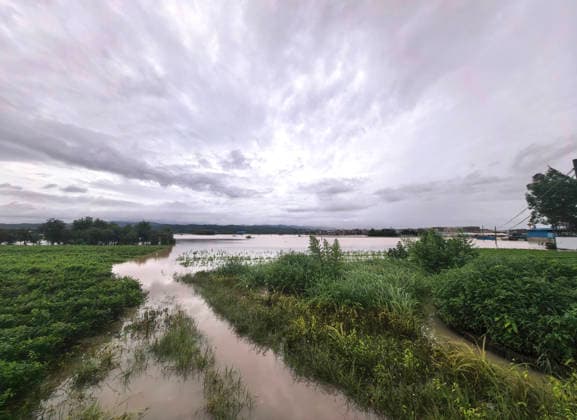 (260706) -- NANNING, July 6, 2026 -- This photo taken on July 6, 2026 shows the flooded downstream areas of the Liulan Reservoir after it was breached due to heavy rains in Hengzhou, Nanning City, south China s Guangxi Zhuang Autonomous Region. A severe breach occurred at a reservoir in Hengzhou, Nanning City, in south China s Guangxi Zhuang Autonomous Region on Monday morning, prompting an immediate escalation of the emergency response, local authorities said. Given the severe flood control situation, the city raised its emergency response for flood control from Level III to Level I, effective at 11:30 a.m. on Monday. The Liulan Reservoir, a medium-sized water conservancy facility in the region, reported the dam breach on Monday mo 