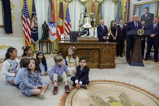 Children sit on the floor as President Donald Trump (R) speaks on the first day of trading for Trump Accounts in the Oval Office of the White House in Washington, DC on Monday, July 6, 2026. Trump Accounts grant eligible US children born between 2026 and 2028 $1000.00 to fund starter IRAs.  WASP20260706110 SHAWNxTHEW