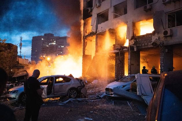 RECORD DATE NOT STATED A man walks past a burning car beside a residential high-rise damaged in a Russian attack, Kyiv, Ukraine, on July 6, 2026. Russian forces launched a large-scale attack on the capital using ballistic and cruise missiles as well as attack drones, causing destruction to apartment buildings and civilian infrastructure across several districts of the city. The Podilskyi district suffered the most severe damage. At least 11 people were killed and 46 others were injured (Photo by Danylo Antoniuk Ukrinform) Russia launches another massive strike on Kyiv  Copyright: xDanyloxAntoniukx