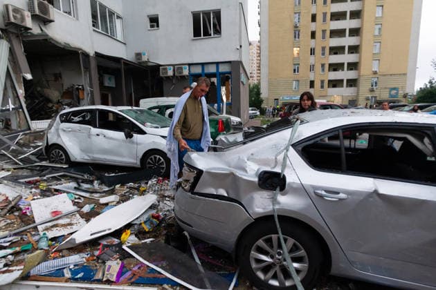 RECORD DATE NOT STATED A man inspects a car damaged in a massive combined Russian attack outside a residential building in Kyiv, Ukraine, on July 6, 2026. Russian forces launched a large-scale attack on the capital using ballistic and cruise missiles as well as attack drones, causing destruction to apartment buildings and civilian infrastructure across several districts of the city. The Podilskyi district suffered the most severe damage. At least 11 people were killed and 46 others were injured (Photo by Kyrylo Chubotin Ukrinform) Russia launches another massive strike on Kyiv  Copyright: xKyryloxChubotinx