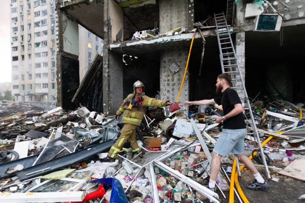 RECORD DATE NOT STATED A man and a rescuer are seen outside a multi-storey residential building damaged in a massive combined Russian attack, Kyiv, Ukraine, on July 6, 2026. Russian forces launched a large-scale attack on the capital using ballistic and cruise missiles as well as attack drones, causing destruction to apartment buildings and civilian infrastructure across several districts of the city. The Podilskyi district suffered the most severe damage. At least 11 people were killed and 46 others were injured (Photo by Kyrylo Chubotin Ukrinform) Russia launches another massive strike on Kyiv  Copyright: xKyryloxChubotinx
