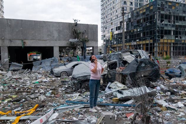 RECORD DATE NOT STATED A woman talks on her phone by a vehicle destroyed in a massive combined Russian attack on Kyiv, Ukraine, on July 6, 2026. Russian forces launched a large-scale attack on the capital using ballistic and cruise missiles as well as attack drones, causing destruction to residential buildings and civilian infrastructure in several districts of the city. The Podilskyi district was hit hardest. At least 11 people were killed and 46 others were injured (Photo by Kyrylo Chubotin Ukrinform) Russia launches another massive strike on Kyiv  Copyright: xKyryloxChubotinx