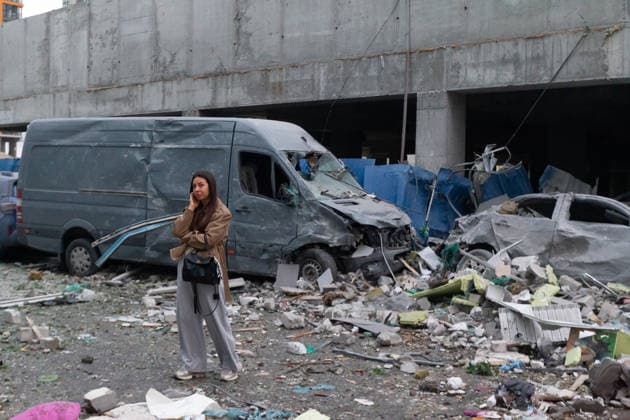 RECORD DATE NOT STATED A woman talks on her phone near vehicles damaged in a massive combined Russian attack on Kyiv, Ukraine, on July 6, 2026. Russian forces launched a large-scale attack on the capital using ballistic and cruise missiles as well as attack drones, causing destruction to residential buildings and civilian infrastructure in several districts of the city. The Podilskyi district was hit hardest. At least 11 people were killed and 46 others were injured (Photo by Kyrylo Chubotin Ukrinform) Russia launches another massive strike on Kyiv  Copyright: xKyryloxChubotinx