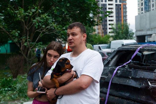 RECORD DATE NOT STATED People with a dog watch emergency responders dealing with the aftermath of a massive combined Russian attack on Kyiv, Ukraine, on July 6, 2026. Russian forces launched a large-scale attack on the capital using ballistic and cruise missiles as well as attack drones, causing destruction to residential buildings and civilian infrastructure in several districts of the city. The Podilskyi district was hit hardest. At least 11 people were killed and 46 others were injured (Photo by Kyrylo Chubotin Ukrinform) Russia launches another massive strike on Kyiv  Copyright: xKyryloxChubotinx