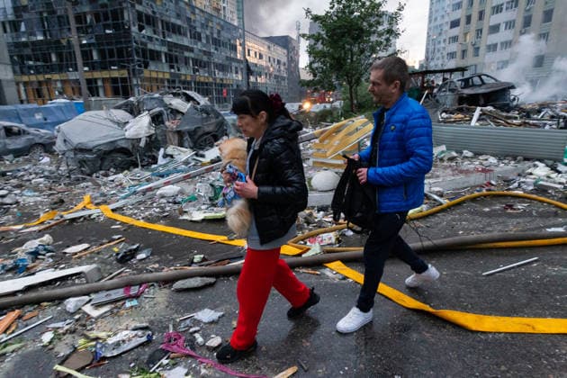 RECORD DATE NOT STATED People walk a dog past a vehicle destroyed in a massive combined Russian attack on Kyiv, Ukraine, on July 6, 2026. Russian forces launched a large-scale attack on the capital using ballistic and cruise missiles as well as attack drones, causing destruction to residential buildings and civilian infrastructure in several districts of the city. The Podilskyi district was hit hardest. At least 11 people were killed and 46 others were injured (Photo by Kyrylo Chubotin Ukrinform) Russia launches another massive strike on Kyiv  Copyright: xKyryloxChubotinx