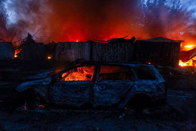 RECORD DATE NOT STATED A car destroyed in a massive combined Russian attack stands beside burning garages in Kyiv, Ukraine, on July 6, 2026. Russian forces launched a large-scale attack on the capital using ballistic and cruise missiles as well as attack drones, causing destruction to apartment buildings and civilian infrastructure across several districts of the city. The Podilskyi district suffered the most severe damage. At least 11 people were killed and 46 others were injured (Photo by Kyrylo Chubotin Ukrinform) Russia launches another massive strike on Kyiv  Copyright: xKyryloxChubotinx