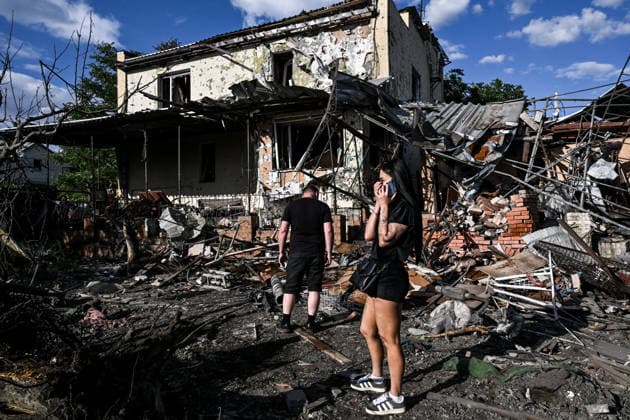 RECORD DATE NOT STATED People stand outside a residential building damaged in a Russian guided bomb attack in Zaporizhzhia, Ukraine, on July 5, 2026. Russian forces struck the city with two guided aerial bombs. One bomb hit near a multi-storey residential building, while the other struck a private residential area. The attack damaged 35 apartments in the apartment building and destroyed private homes. More than ten people were injured, and a police officer was killed (Photo by Dmytro Smolienko Ukrinform) Russian forces strike Zaporizhzhia with two guided bombs  Copyright: xDmytroxSmolienkox