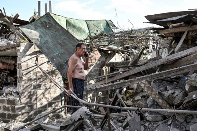 RECORD DATE NOT STATED A man talks on the phone outside a residential building damaged in a Russian guided bomb attack in Zaporizhzhia, Ukraine, on July 5, 2026. Russian forces struck the city with two guided aerial bombs. One bomb hit near a multi-storey residential building, while the other struck a private residential area. The attack damaged 35 apartments in the apartment building and destroyed private homes. More than ten people were injured, and a police officer was killed (Photo by Dmytro Smolienko Ukrinform) Russian forces strike Zaporizhzhia with two guided bombs  Copyright: xDmytroxSmolienkox