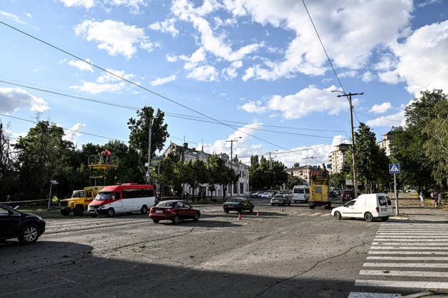 RECORD DATE NOT STATED Cars pass by electrical workers repairing the overhead trolleybus power network damaged in a Russian guided bomb attack in Zaporizhzhia, Ukraine, on July 5, 2026. Russian forces struck the city with two guided aerial bombs. One bomb hit near a multi-storey residential building, while the other struck a private residential area. The attack damaged 35 apartments in the apartment building and destroyed private homes. More than ten people were injured, and a police officer was killed (Photo by Dmytro Smolienko Ukrinform) Russian forces strike Zaporizhzhia with two guided bombs  Copyright: xDmytroxSmolienkox