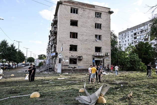RECORD DATE NOT STATED People stand outside a five-storey residential building damaged in a Russian guided bomb attack in Zaporizhzhia, Ukraine, on July 5, 2026. Russian forces struck the city with two guided aerial bombs. One bomb hit near a multi-storey residential building, while the other struck a private residential area. The attack damaged 35 apartments in the apartment building and destroyed private homes. More than ten people were injured, and a police officer was killed (Photo by Dmytro Smolienko Ukrinform) Russian forces strike Zaporizhzhia with two guided bombs  Copyright: xDmytroxSmolienkox
