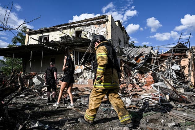 RECORD DATE NOT STATED People stand outside a residential building damaged in a Russian guided bomb attack in Zaporizhzhia, Ukraine, on July 5, 2026. Russian forces struck the city with two guided aerial bombs. One bomb hit near a multi-storey residential building, while the other struck a private residential area. The attack damaged 35 apartments in the apartment building and destroyed private homes. More than ten people were injured, and a police officer was killed (Photo by Dmytro Smolienko Ukrinform) Russian forces strike Zaporizhzhia with two guided bombs  Copyright: xDmytroxSmolienkox