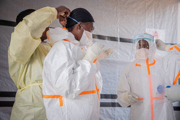 (260706) -- BUNIA, July 6, 2026 -- Medical workers put on protective suits at an Ebola treatment center in Bunia, the capital of Ituri Province in the Democratic Republic of the Congo, July 6, 2026. The death toll from the latest Ebola outbreak in the Democratic Republic of the Congo has surpassed 500, according to a report released Sunday by the country s health authorities. DR CONGO-BUNIA-EBOLA OUTBREAK-DEATH XinxHuashefa 