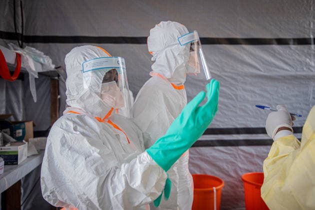 (260706) -- BUNIA, July 6, 2026 -- Medical workers put on protective suits at an Ebola treatment center in Bunia, the capital of Ituri Province in the Democratic Republic of the Congo, July 6, 2026. The death toll from the latest Ebola outbreak in the Democratic Republic of the Congo has surpassed 500, according to a report released Sunday by the country s health authorities. DR CONGO-BUNIA-EBOLA OUTBREAK-DEATH XinxHuashefa 