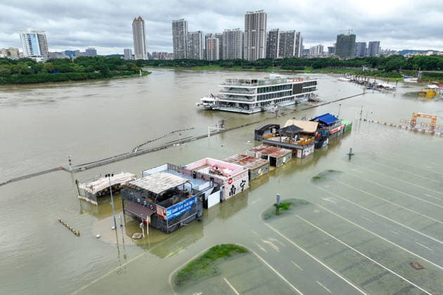 NANNING, CHINA - JULY 06: Aerial view of shops and a parking lot submerged in flood water on July 6, 2026 in Nanning, Guangxi Zhuang Autonomous Region of China. Local authorities launched a Level-IV flood emergency response as the river exceeded warning levels following heavy rainfall brought by typhoon Maysak.  Copyright: xChinaxNewsxServicex 111652649628