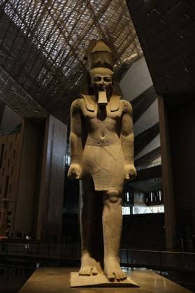 People walk past a statue of King Ramses II at the entrance of the Grand Egyptian Museum (GEM), in Giza, Egypt Cairo, Egypt July 6, 2026: The colossal statue of King Ramesses II dominates the Grand Hall of the Grand Egyptian Museum (GEM), welcoming visitors at the museum s main entrance. Standing approximately 11 meters tall and weighing around 83 tons, the red granite masterpiece dates back more than 3,200 years to Egypt s 19th Dynasty. Originally discovered in the ancient city of Memphis, the statue symbolizes the power and legacy of one of ancient Egypt s greatest pharaohs. Today, it serves as one of the Grand Egyptian Museum s most iconic landmarks, reflecting the grandeur of Egypt s rich archaeological Mahmoud Ghany Giza Egypt Copyright: x xMahmoudxAhmedxabdxelghanyx xJNAxPressx