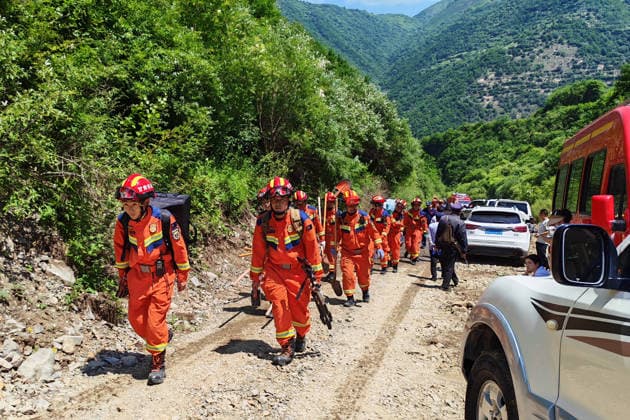 (260707) -- TANCHANG, July 7, 2026 -- Rescuers march toward the site of a landslide that took place at a village in Nanhe township of Tanchang County, Longnan City, northwest China s Gansu Province, July 7, 2026. A landslide struck a township in Tanchang County, early on Tuesday morning, leaving multiple people missing. The landslide occurred at a village in Nanhe township at around 6:56 a.m., according to local authorities. A total of 33 people are believed to be buried, and 17 of them have been rescued. Photo Flash Landslide in northwest China s Gansu leaves multiple people missing, 17 rescued LiuxHui 