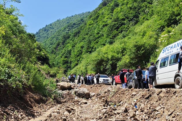 (260707) -- TANCHANG, July 7, 2026 -- Rescuers work at the site of a landslide that took place at a village in Nanhe township of Tanchang County, Longnan City, northwest China s Gansu Province, July 7, 2026. A landslide struck a township in Tanchang County early on Tuesday morning, leaving multiple people missing. The landslide occurred at a village in Nanhe township at around 6:56 a.m., according to local authorities. A total of 33 people are believed to be buried, and 17 of them have been rescued. All-out search and rescue operations are underway. (SpotNews)CHINA-GANSU-TANCHANG-LANDSLIDE-RESCUE (CN) LiuxHui 