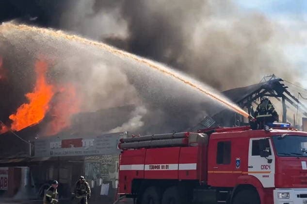 RUSSIA, IZHEVSK - JULY 7, 2026: Firefighters battle a fire at a warehouse distribution center. Video grab. Best quality available. Russia Emergencies Ministry TASS  94776617