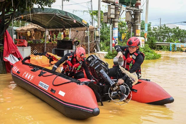 (260707) -- HENGZHOU, July 7, 2026 -- Rescuers clear accumulated water from a rubber boat in Hengzhou of Nanning City, south China s Guangxi Zhuang Autonomous Region, July 6, 2026. Record-breaking rainfall and the ensuing floods in parts of Nanning, capital city of south China s Guangxi Zhuang Autonomous Region, have left four people dead and eight others missing as of 10 a.m. Tuesday, according to a press conference on flood prevention and disaster relief held in Nanning. Hengzhou City and Binyang County, both currently under the jurisdiction of Nanning, recently experienced rainfall that broke local 24-hour meteorological records. The reported casualties were all in Hengzhou. ) CHINA-GUANGXI-NANNING-FLOOD-RESCUE (CN) CaoxYiming 