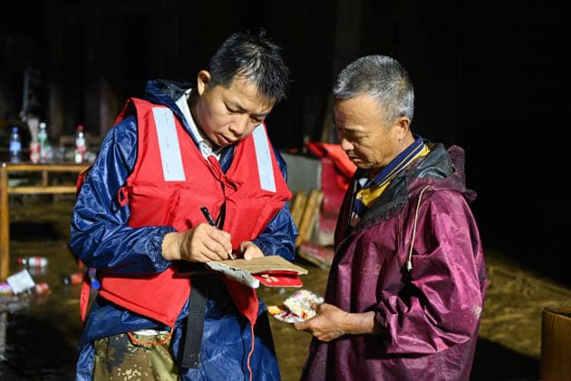 (260707) -- HENGZHOU, July 7, 2026 -- A local official (L) collects information on affected people in Hengzhou of Nanning City, south China s Guangxi Zhuang Autonomous Region, July 7, 2026. Record-breaking rainfall and the ensuing floods in parts of Nanning, capital city of south China s Guangxi Zhuang Autonomous Region, have left four people dead and eight others missing as of 10 a.m. Tuesday, according to a press conference on flood prevention and disaster relief held in Nanning. Hengzhou City and Binyang County, both currently under the jurisdiction of Nanning, recently experienced rainfall that broke local 24-hour meteorological records. The reported casualties were all in Hengzhou. ) CHINA-GUANGXI-NANNING-FLOOD-RESCUE (CN) CaoxYimi 