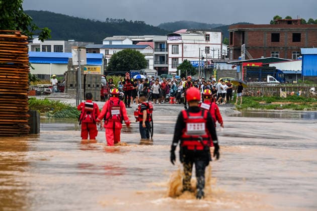 (260707) -- HENGZHOU, July 7, 2026 -- Rescuers wade through floodwaters during rescue operations in Hengzhou of Nanning City, south China s Guangxi Zhuang Autonomous Region, July 6, 2026. Record-breaking rainfall and the ensuing floods in parts of Nanning, capital city of south China s Guangxi Zhuang Autonomous Region, have left four people dead and eight others missing as of 10 a.m. Tuesday, according to a press conference on flood prevention and disaster relief held in Nanning. Hengzhou City and Binyang County, both currently under the jurisdiction of Nanning, recently experienced rainfall that broke local 24-hour meteorological records. The reported casualties were all in Hengzhou. ) CHINA-GUANGXI-NANNING-FLOOD-RESCUE (CN) CaoxYiming 
